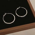 Close-up of silver hoop earrings featuring faceted metal beads on a black display tray - Faceted Metal Bead Decoration (A-1115) / Silver
