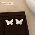 Macro shot of silver butterfly stud earrings with fine texture on a velvet jewelry box - Matte Silver Butterfly Stud Earrings