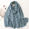 Lightweight blue geometric scarf with gold foil accents and fringe, styled on a magazine - Blue Geometric Style (SL2209-017 Blue)