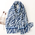 Detail of blue and white leopard animal print scarf with frayed edges and cotton feel - Blue