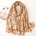 Close-up of tiger print scarf texture with raw edges and soft cotton linen feel - Khaki