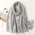 Close-up of light grey scarf with golden rhombus pattern and soft linen-feel texture - Gray