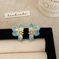 Macro detail of blue and white enamel flower stud earrings with sparkling zircon centers - Blue Petal Stud Earrings
