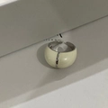 Detailed macro view of an adjustable silver ring with ivory enamel inlay and central split line - White