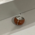 Macro view of French retro enamel ring in caramel brown and silver with open band detail - Reddish Brown