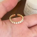 Elegant gold-plated open ring with white enamel rectangles shown on hand display - White Enamel Ring