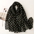 Black lightweight scarf with gold foil diamond patterns on white background with props - Black