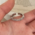 Detailed view of an adjustable silver ring with sparkling round-cut cubic zirconia stones - Adjustable Micro-pavé Style / Silver