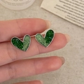 Elegant green crystal heart studs with silver metal frame held in hand for detail - Silver Heart Style (A-1004)