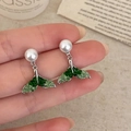 Detailed shot of pearl earrings featuring silver whale tails with green stone inlay - Pearl Fishtail Stud Style (A-1086)