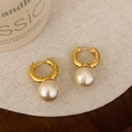 Elegant gold hoop earrings with large matte white pearls on textured linen background - Gold 10mm Round Cotton Pearl Style