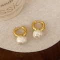 Elegant gold hoop earrings featuring unique white textured baroque-style pearl drops - Gold 10mm Bun Cotton Pearl Style