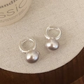 Macro detail of silver metal hoop earrings with elegant grey pearls on linen texture - Silver 10mm Manta Rose Bun Pearl Style