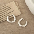 Macro view of silver matte brushed hoop earrings with pin closure on linen fabric - Heavy Hoop Style (A-1519)
