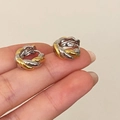 Pendientes de aro bicolores oro y plata con un elegante diseño de metal trenzado - Pendientes Torcidos Oro Plata