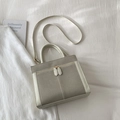Dettaglio della borsa in pelle grigio opaco e bianco su sfondo di tessuto bianco - Senza Ciondolo / Bianco