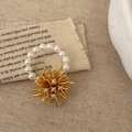Luxury dandelion ring with gold spark design and pearls on textured linen background - Gold with White Pearl