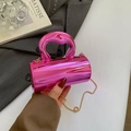 Chic magenta acrylic cylinder handbag with sleek top handle and gold chain strap - Pink