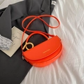 Fashionable bright orange saddle shoulder bag with golden ring and brand lettering - Orange
