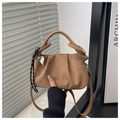 Detail of pleated brown faux suede cloud bag with heart charm and knotted top handle - Brown + Pendant