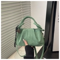 Detail of green suede cloud bag with pleated design and heart charm on braided handle - Green With Charm