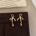 Elegant gold bow ribbon stud earrings in a vintage minimalist design on a velvet tray - Gold