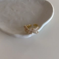 Detailed macro view of gold ribbon knot ring with shimmering pavé zircon stones - Bowknot Zircon Gold Open Ring (C-178)