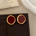 Vintage irregular gold and deep red enamel stud earrings on luxury velvet display card - Red Enamel Stud Earrings
