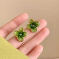 Close-up of handmade gradient green crystal flower studs with gold braided edge - Green Flower Studs