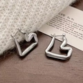 Macro shot of silver irregular heart earrings on a wooden stand with soft knit background - Heart Hoop Earrings (A-306)