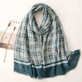 Close-up of blue plaid scarf with gold metallic threads and delicate fringe edges - Blue