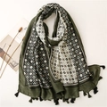 Detailed top view of dark green scarf with geometric patterns and fringe tassels - Green