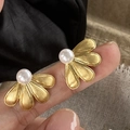 Macro detail of golden brushed flower petal stud earring with center white pearl inlay - Brushed Gold Pearl Earrings