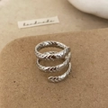 Close-up of a silver spiral wrap ring with intricate engraved feather texture details - Silver