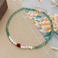 Green stone and freshwater pearl necklace with vintage gold clasp and embroidery background - Necklace