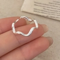 Macro shot of silver wavy irregular open ring with sleek minimalist curved design - Silver Wave Ring