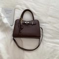 Dark brown pebbled leather handbag with gold twist lock and woven tassel detail - Brown