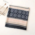 Detailed close-up of navy and orange geometric patterns with soft fringe on a linen scarf - Navy Blue