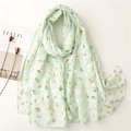 Detail of light mint green scarf with gold leopard print and elegant fabric texture - Mint Green