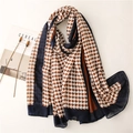 Elegant houndstooth scarf with blue borders displayed with lifestyle props in top view - Off-white