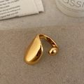 Minimalist gold teardrop open ring with a polished sculptural finish in warm lighting - Shiny Gold Ring