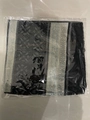 Linen feel scarf in black, grey and white geometric print with tassels in a package - Black