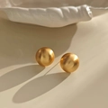 Close-up of golden round stud earrings featuring a refined brushed matte metal texture - Brushed Gold