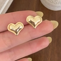 Elegant gold double heart stud earrings with a polished finish and 3D layered design - Gold Heart Stud Earrings