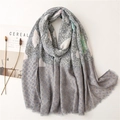 Close-up of soft paisley scarf with grey stripes and blue geometric patterns - Gray