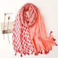 Close-up of floral print cotton scarf with geometric patterns and tassel details - Red
