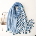 Floral geometric print linen-feel scarf with tassels shown at a 45-degree angle - Blue