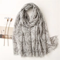 Macro view of grey floral pattern scarf with soft tassels and elegant cotton-linen texture - Gray