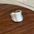 Detailed close-up of a silver brushed wide open ring on a textured wooden background - Silver Brushed Style / Silver
