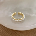 Detailed view of bamboo-textured gold ring with white pearl inlay on a decorative tray - Golden Shell Pearl (C-306)